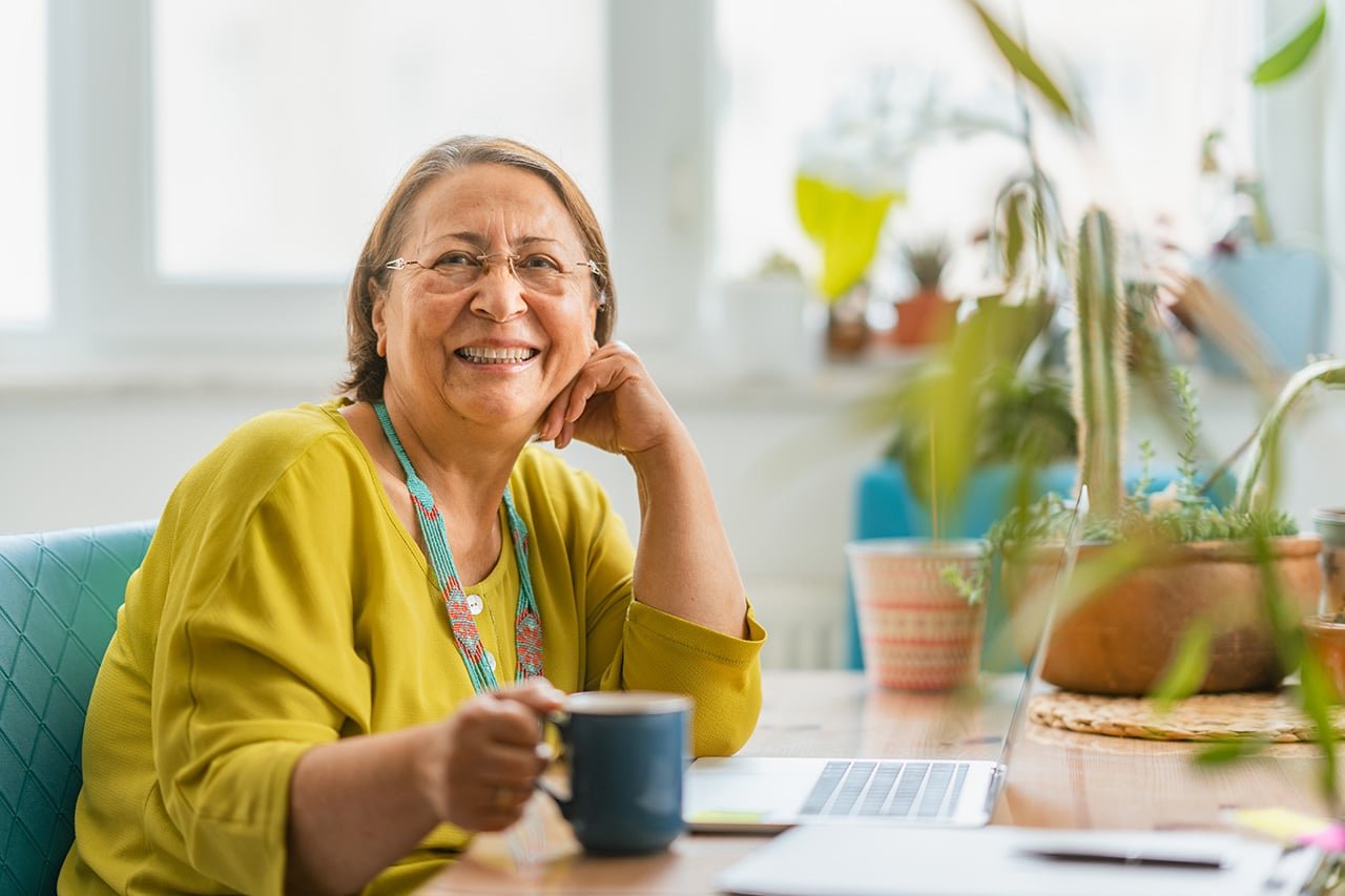 Business owner at desk drinking tea